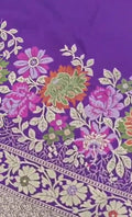 A soft lilac Banarasi semi Katan silk saree with a minimalist plain body, intricate multi-colored Tilfi Meenakari floral borders, and a matching gold zari brocade blouse.