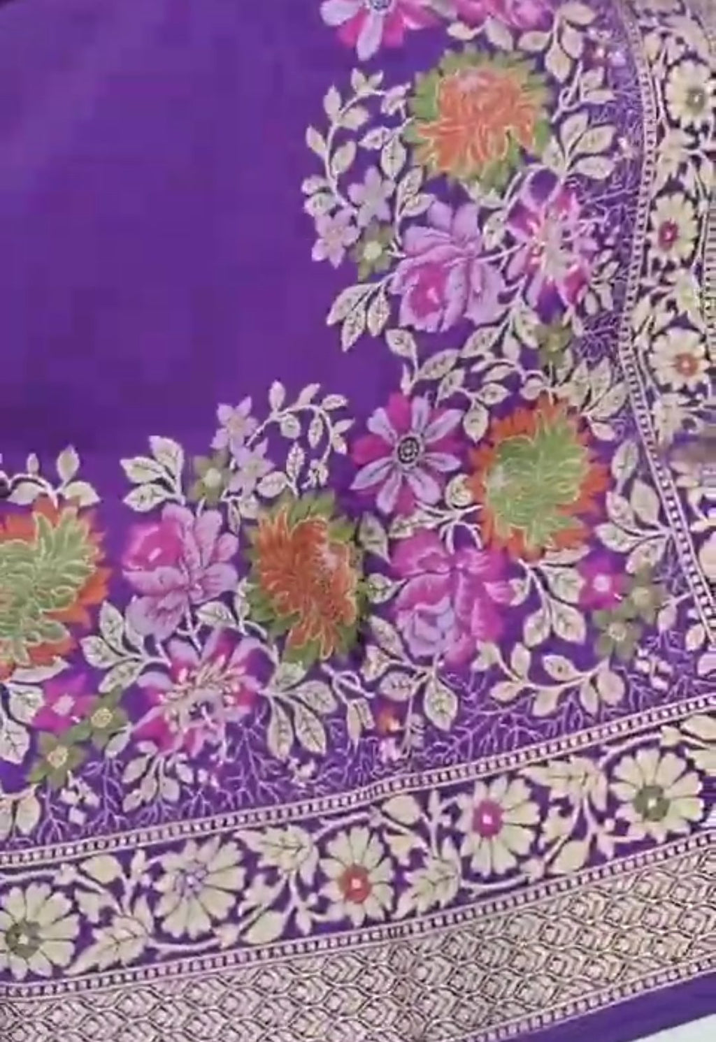 A soft lilac Banarasi semi Katan silk saree with a minimalist plain body, intricate multi-colored Tilfi Meenakari floral borders, and a matching gold zari brocade blouse.