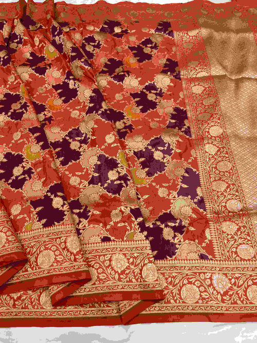 A vibrant chilly red Banarasi Katan silk saree featuring rare Rangkaat diagonal color blocking and multi-hued Meenakari floral weaving.
