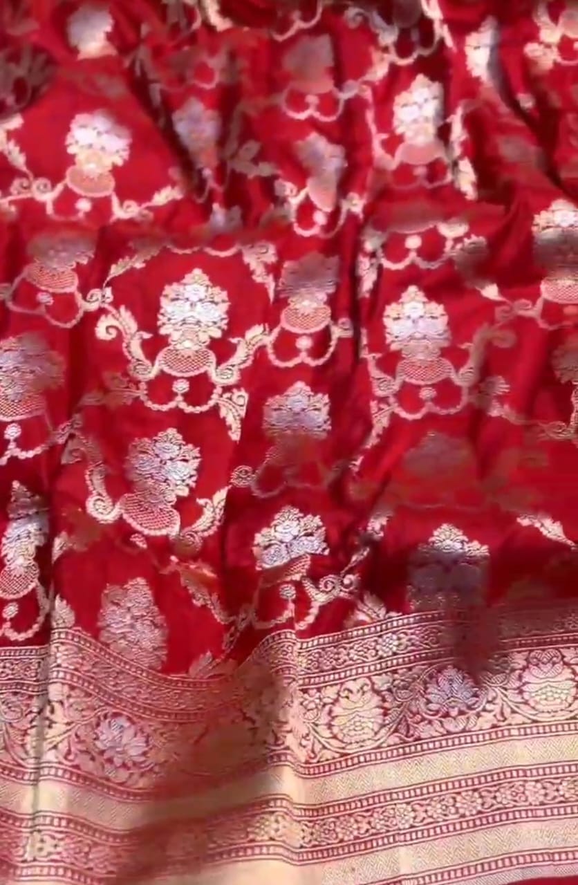 A bridal red Banarasi Katan silk saree featuring intricate hand-woven Sona Rupa zari motifs in gold and silver.