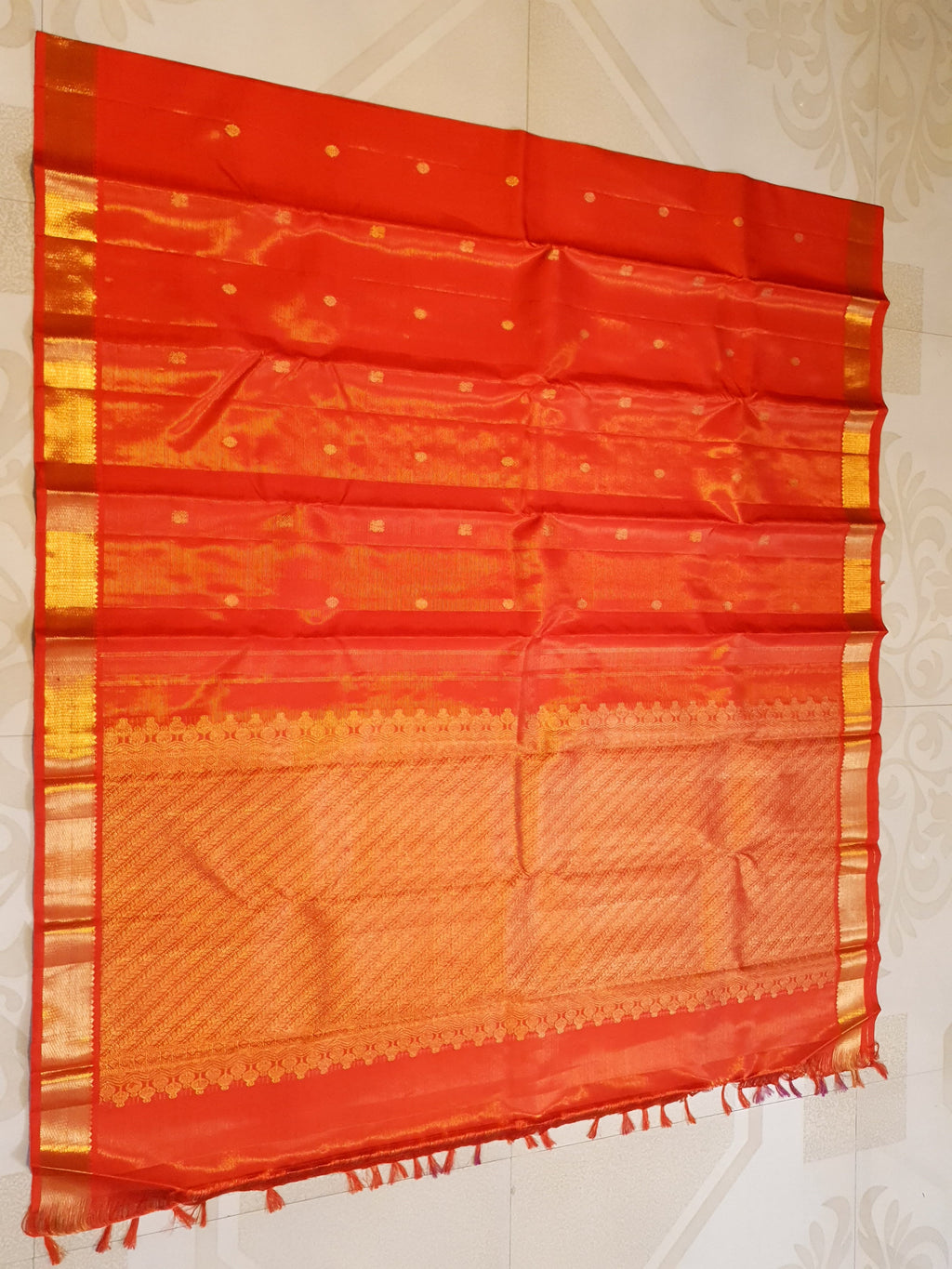 Vibrant Chilly Red Kanjivaram silk saree with a traditional gold zari border and small buttis.
