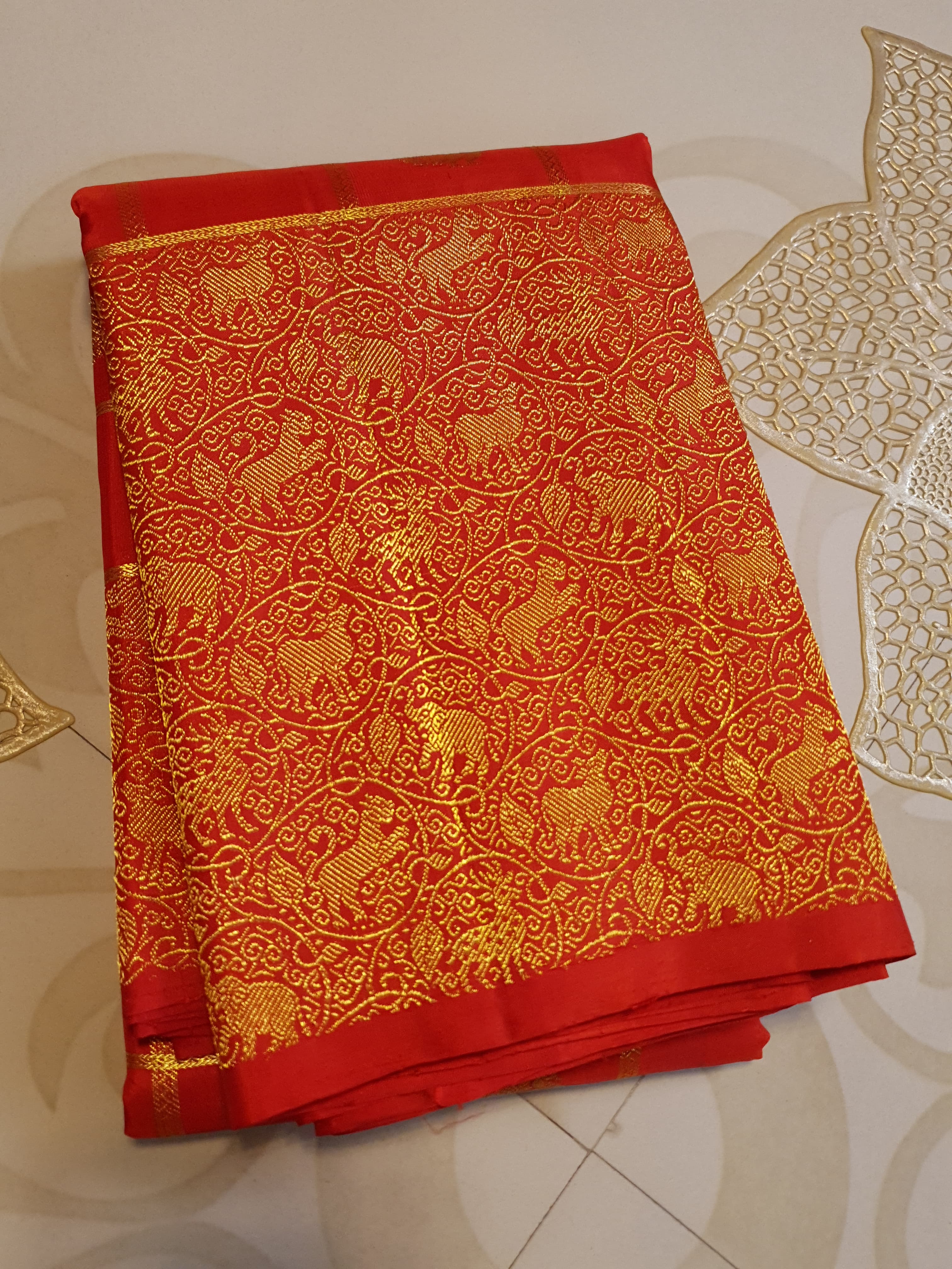 Chilly Red Kanchipuram Handloom 2G Gold Pattu Silk Saree with golden grid patterns, ornate animal-motif borders, and an opulent gold zari pallu.