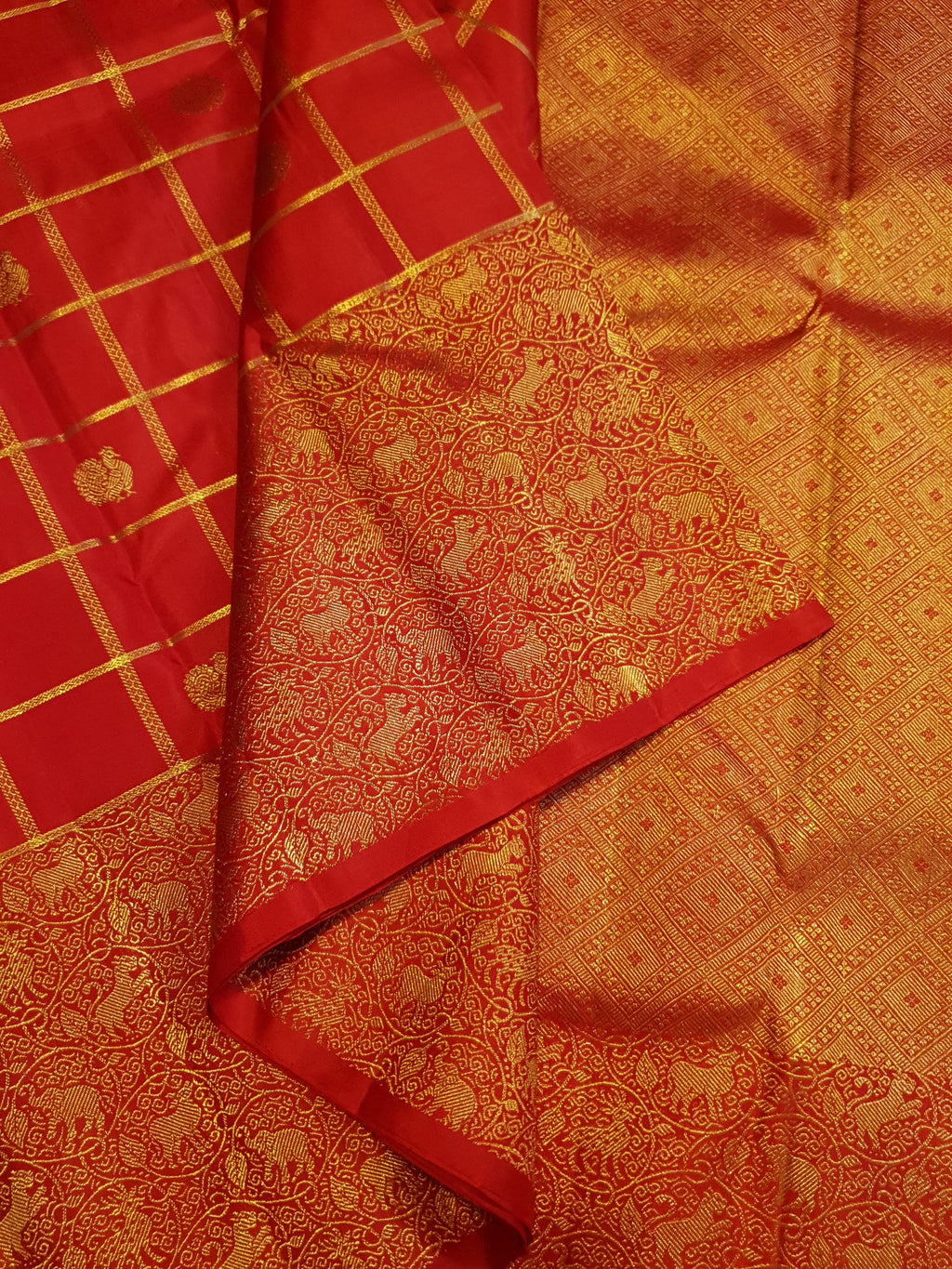 Chilly Red Kanchipuram Handloom 2G Gold Pattu Silk Saree with golden grid patterns, ornate animal-motif borders, and an opulent gold zari pallu.