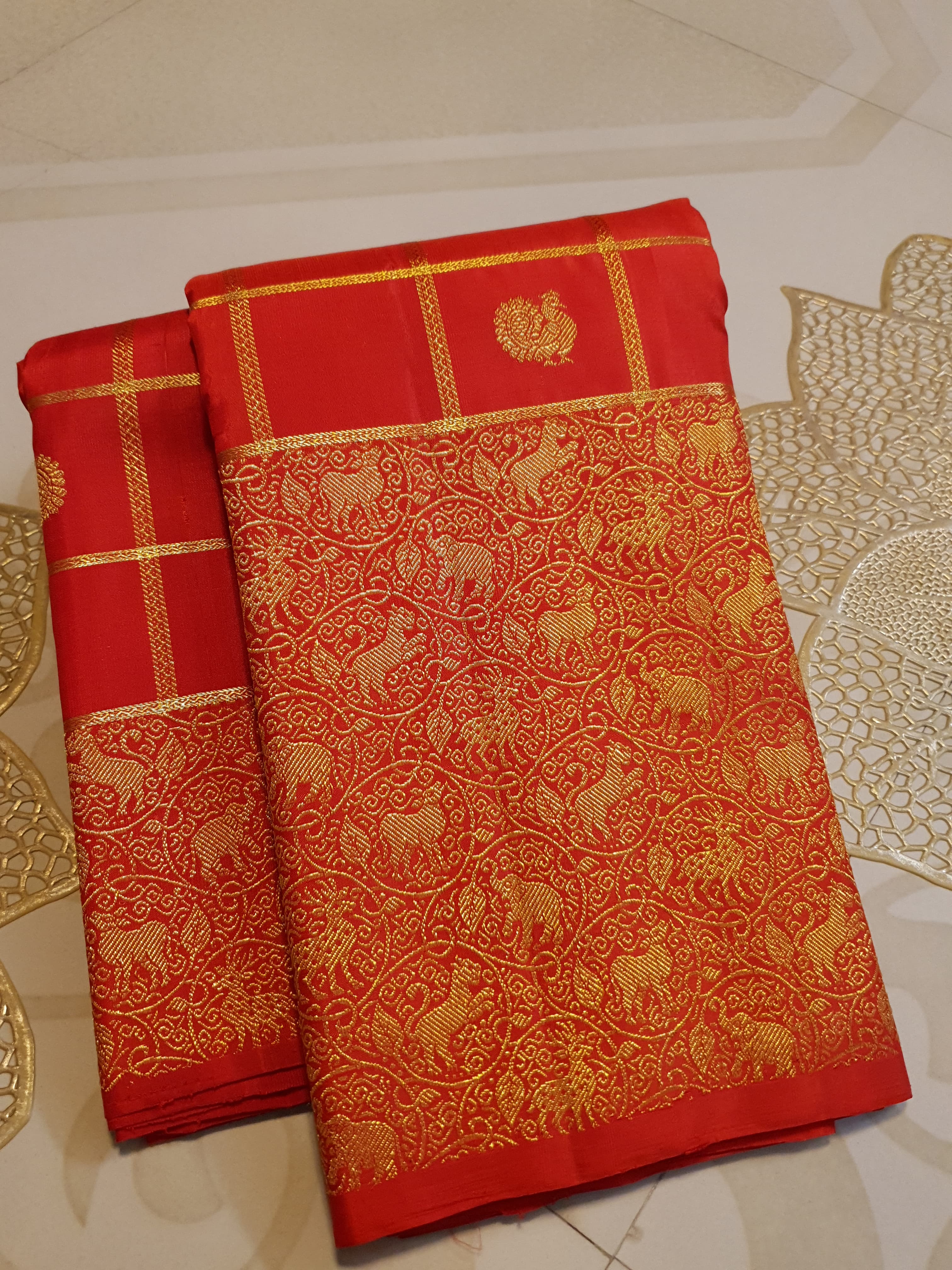 Chilly Red Kanchipuram Handloom 2G Gold Pattu Silk Saree with golden grid patterns, ornate animal-motif borders, and an opulent gold zari pallu.