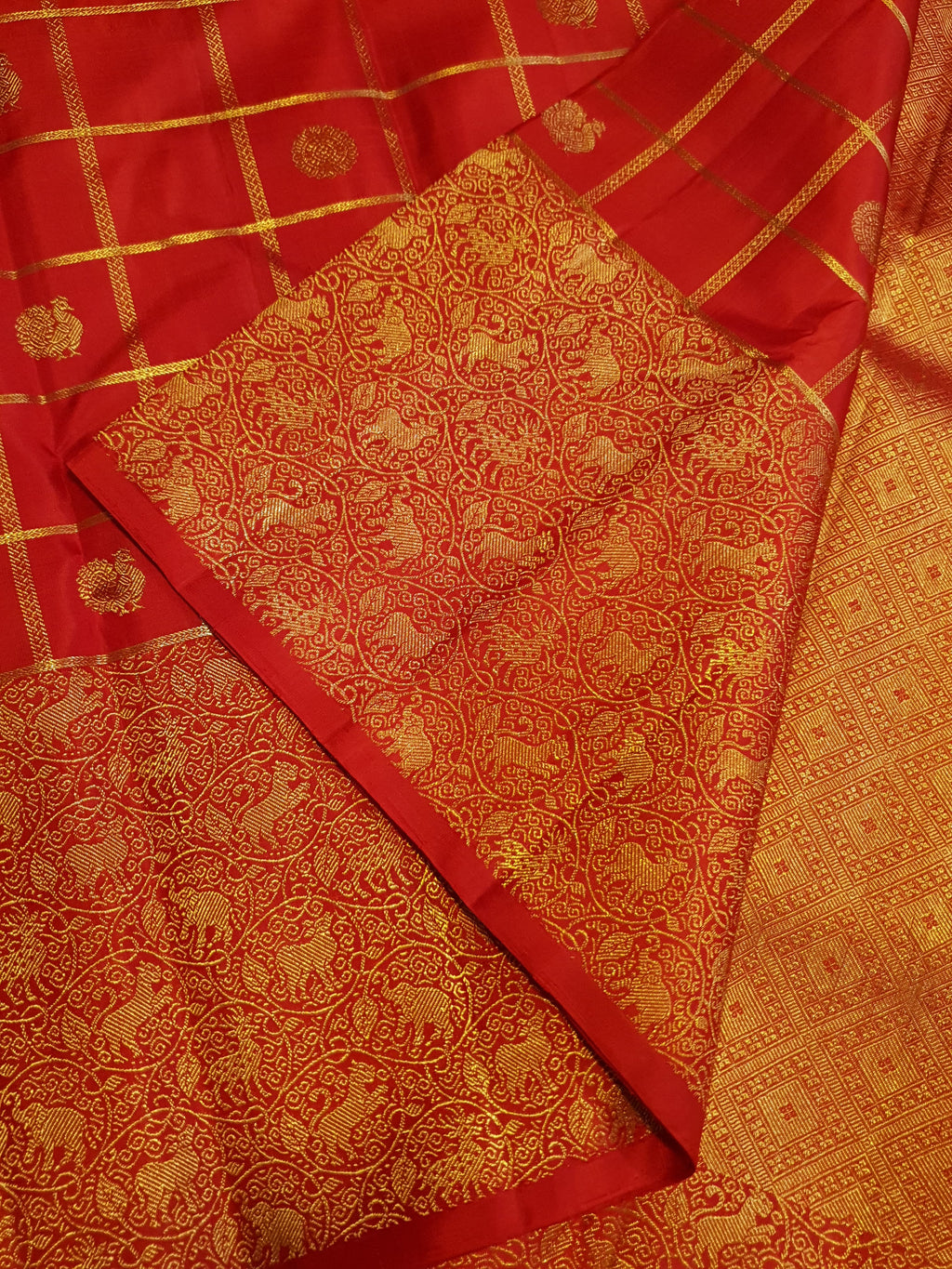 Chilly Red Kanchipuram Handloom 2G Gold Pattu Silk Saree with golden grid patterns, ornate animal-motif borders, and an opulent gold zari pallu.