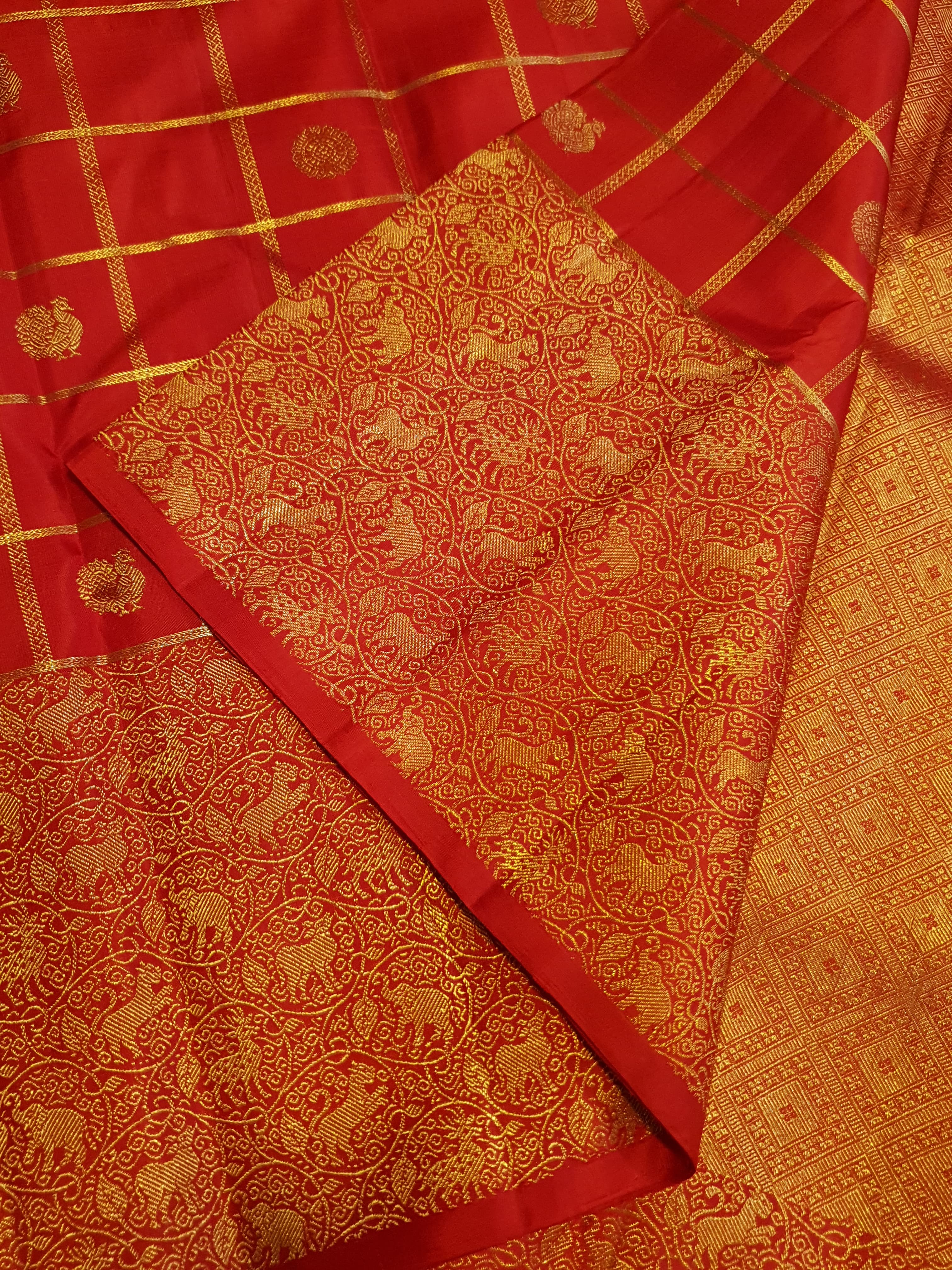 Chilly Red Kanchipuram Handloom 2G Gold Pattu Silk Saree with golden grid patterns, ornate animal-motif borders, and an opulent gold zari pallu.
