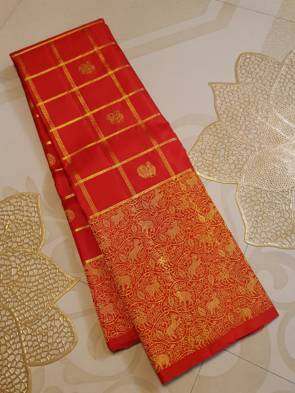 Chilly Red Kanchipuram Handloom 2G Gold Pattu Silk Saree with golden grid patterns, ornate animal-motif borders, and an opulent gold zari pallu.