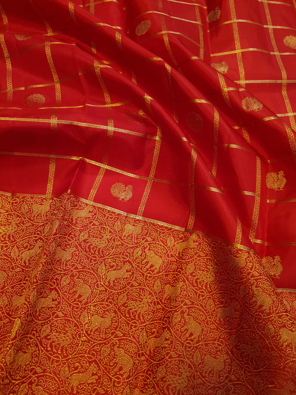 Chilly Red Kanchipuram Handloom 2G Gold Pattu Silk Saree with golden grid patterns, ornate animal-motif borders, and an opulent gold zari pallu.