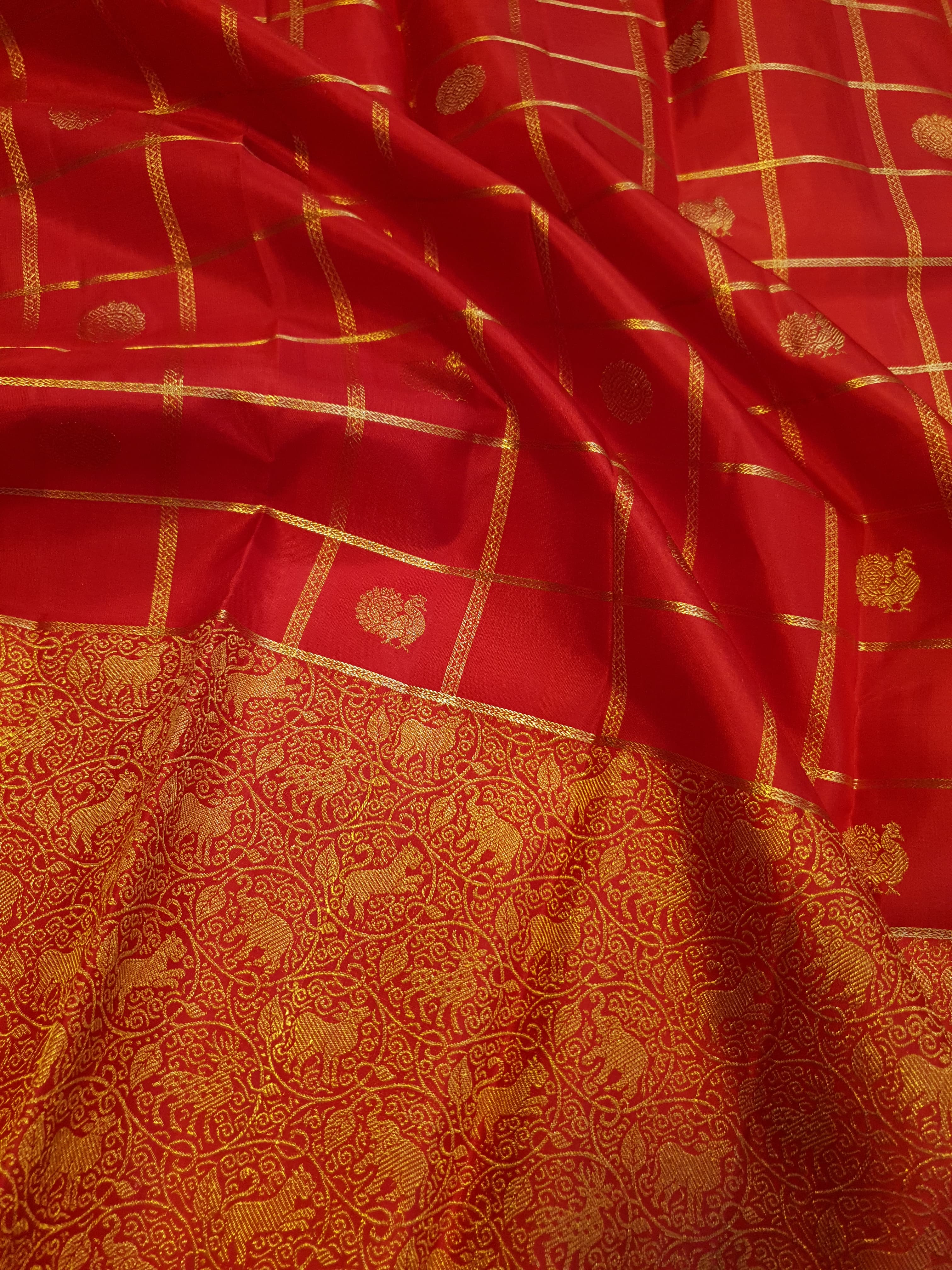 Chilly Red Kanchipuram Handloom 2G Gold Pattu Silk Saree with golden grid patterns, ornate animal-motif borders, and an opulent gold zari pallu.