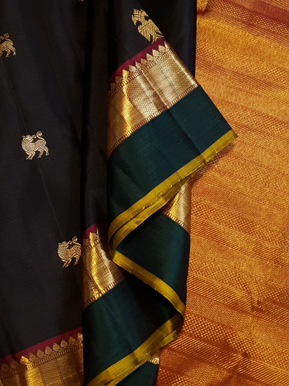 Darkest Purple Kanchipuram Handloom 2G Gold Pattu Silk Saree with Bottle Green and Red borders.
