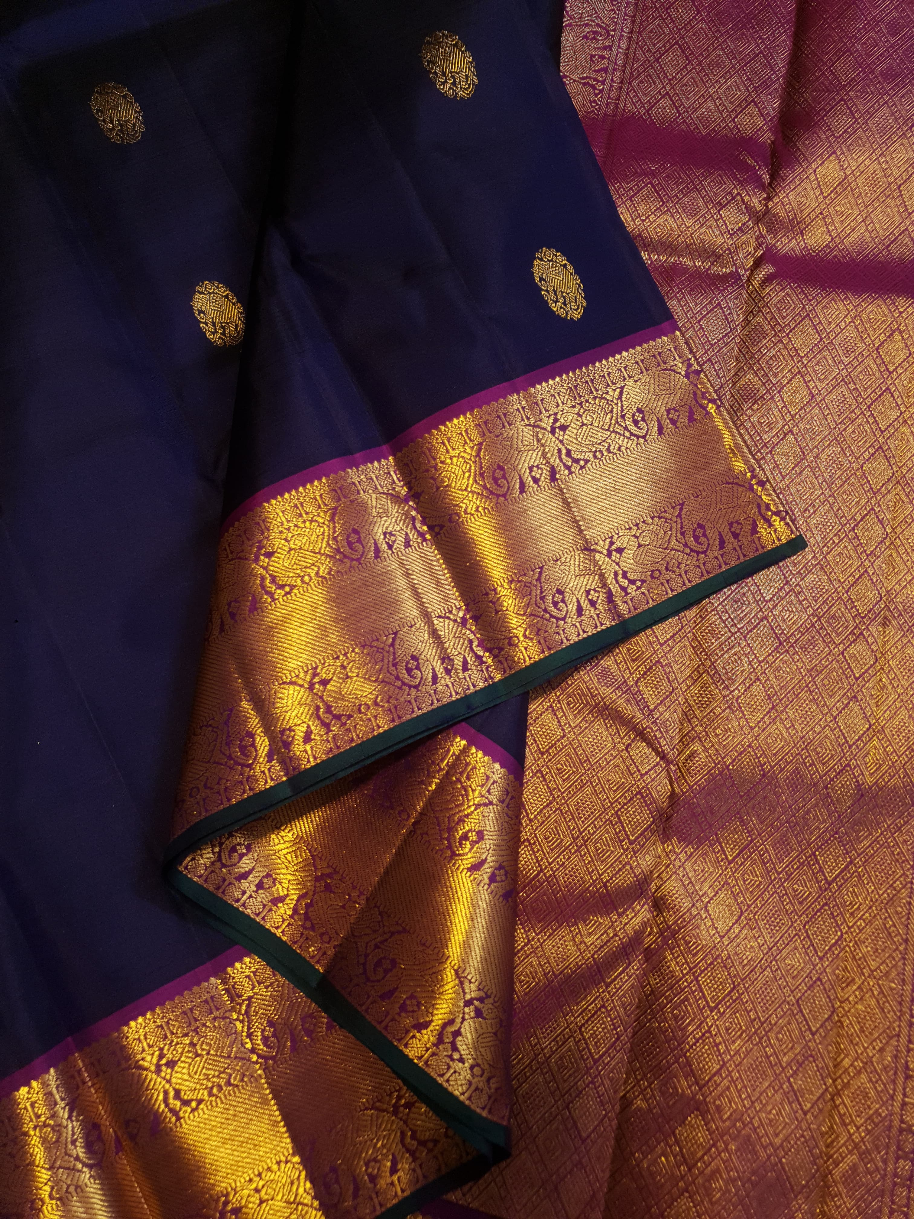Purple Kanchipuram handloom pattu silk saree featuring intricate 2G gold motifs, a rich contrasting magenta pallu, matching magenta borders, and a certified silk mark wea