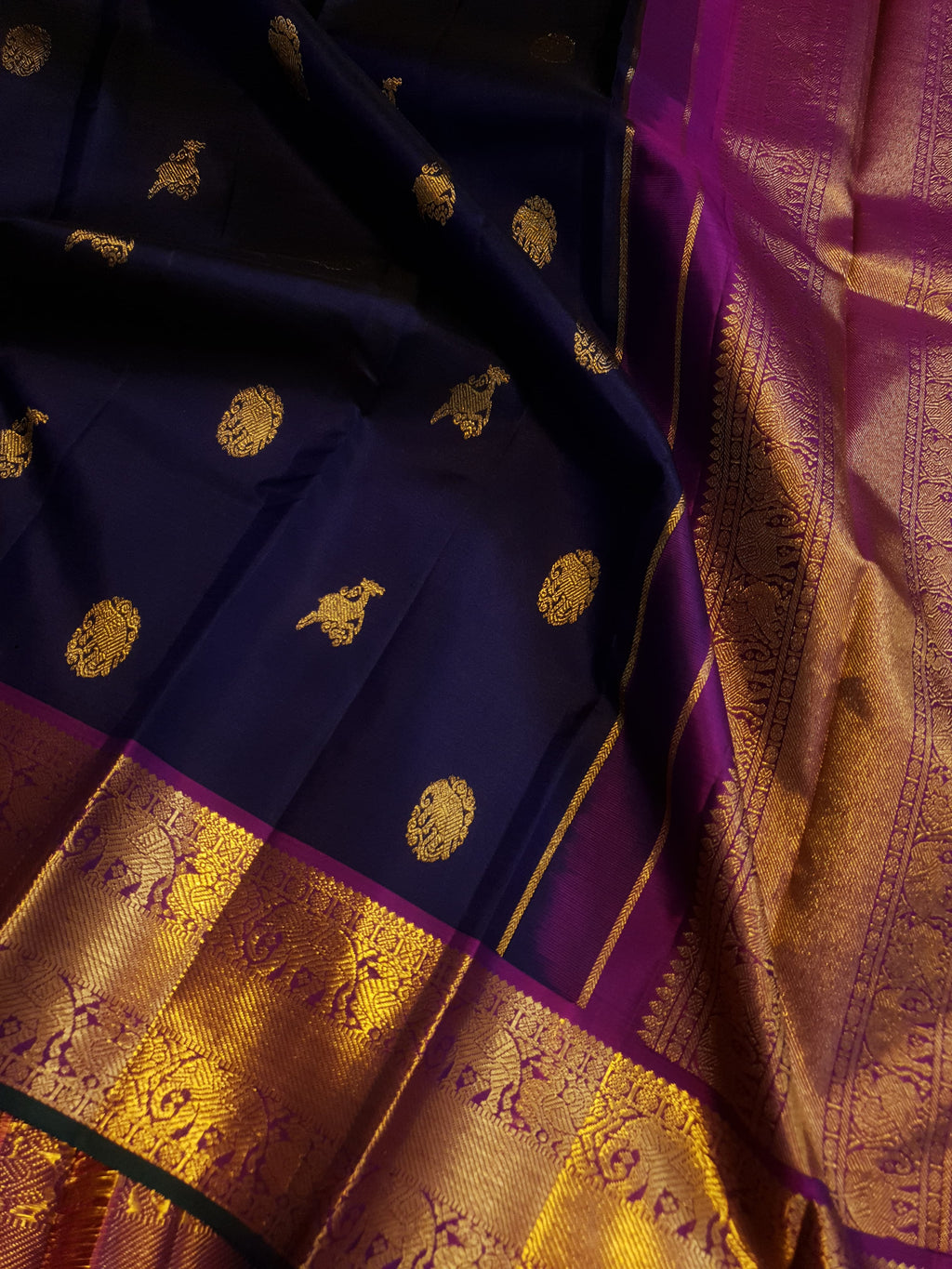 Purple Kanchipuram handloom pattu silk saree featuring intricate 2G gold motifs, a rich contrasting magenta pallu, matching magenta borders, and a certified silk mark wea