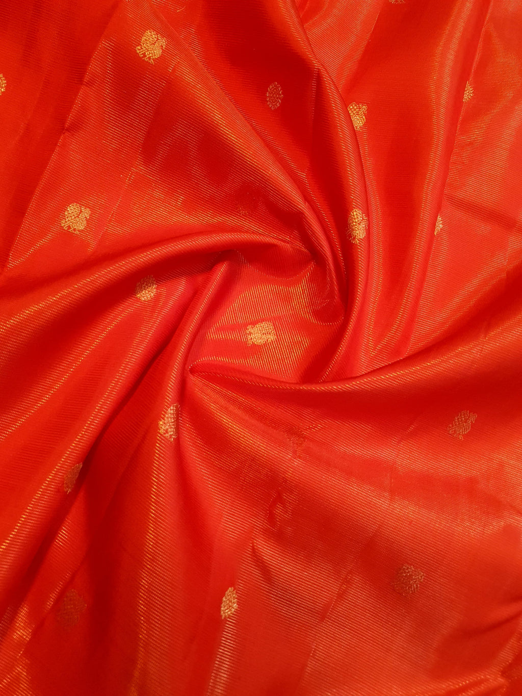 Vibrant Chilly Red Kanjivaram silk saree with a traditional gold zari border and small buttis.