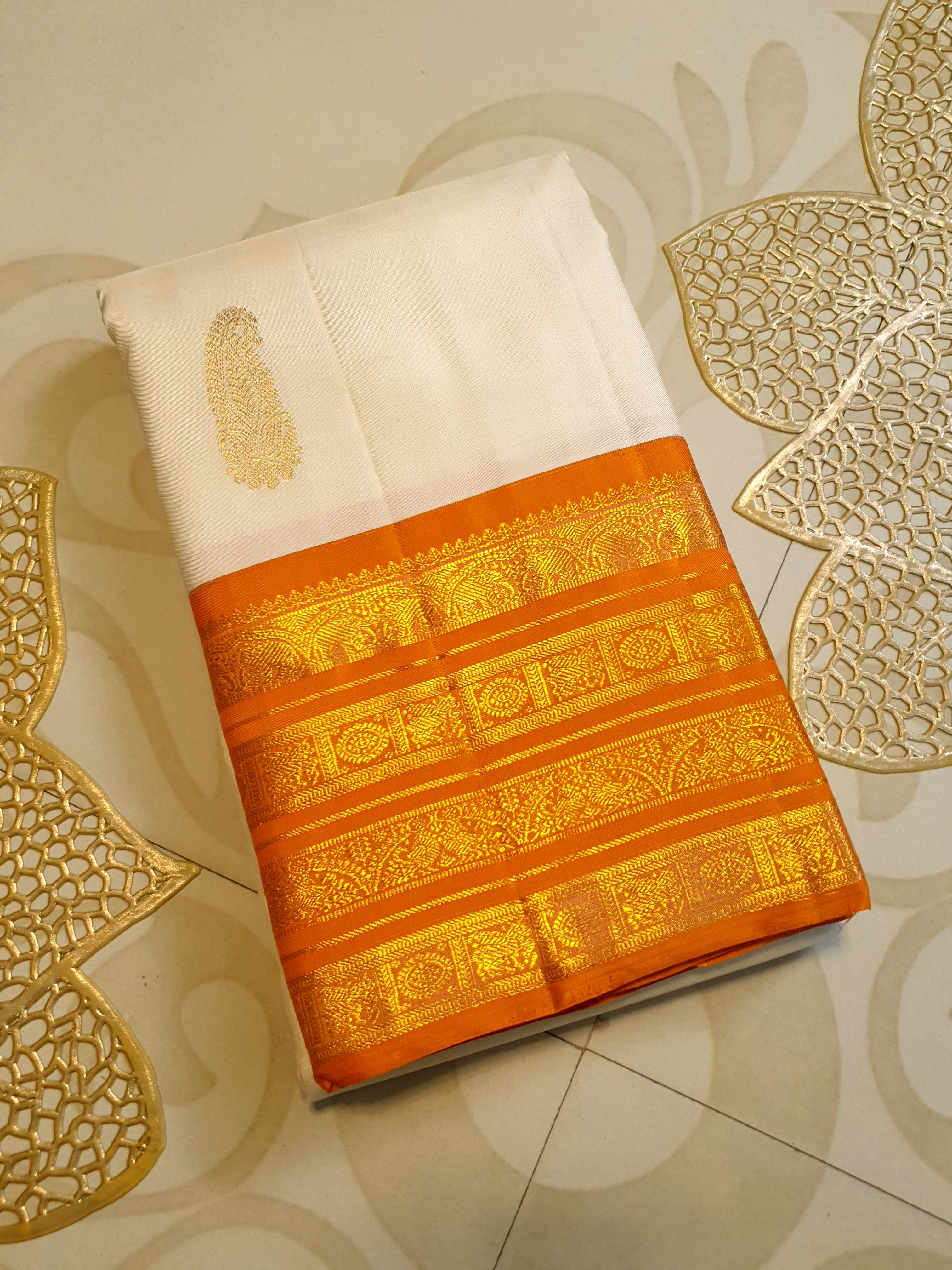 Cream and Orange Kanchipuram handloom 2G gold korvai silk saree featuring traditional gold zari weaving and classic paisley buttis.