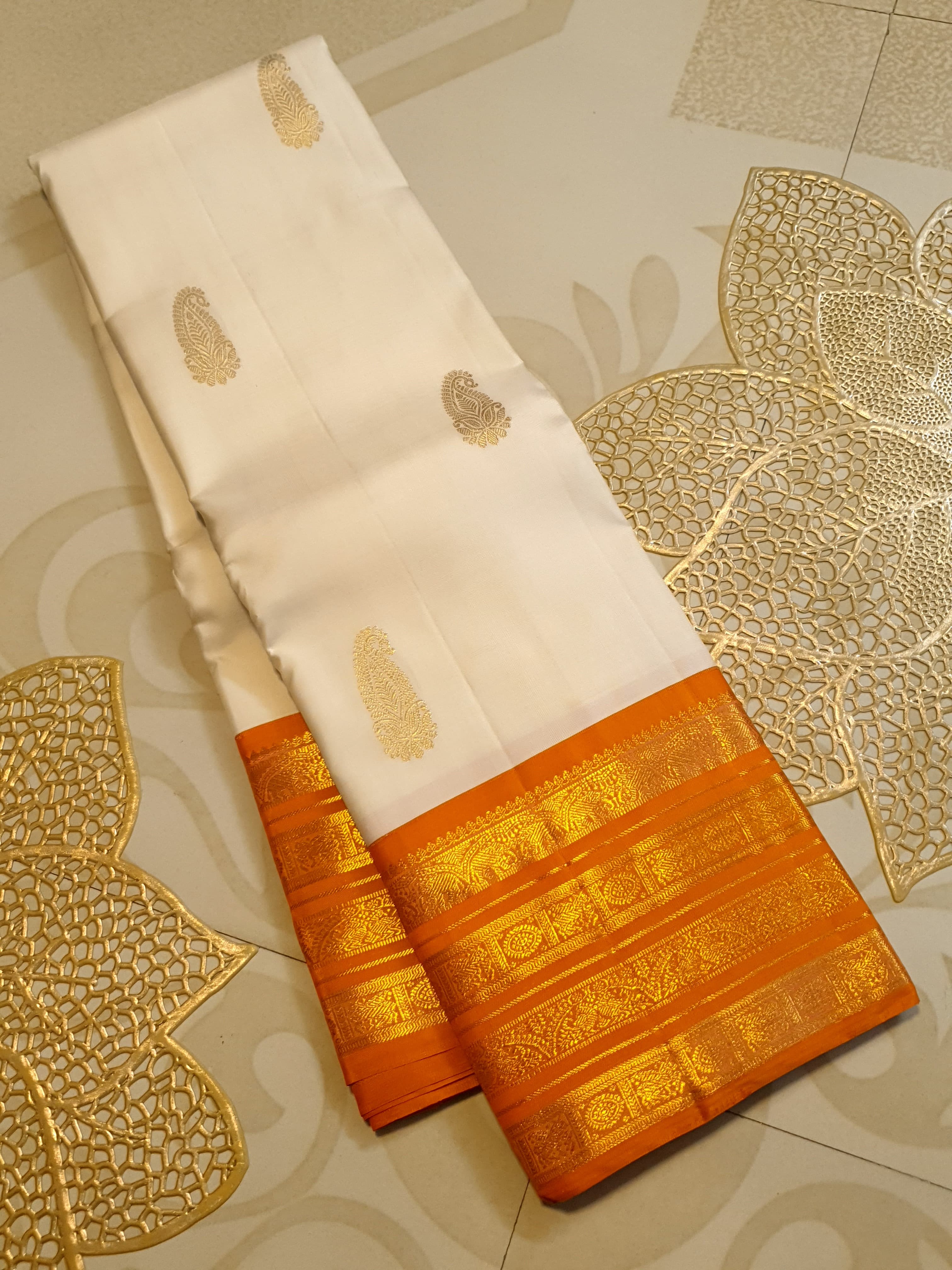 Cream and Orange Kanchipuram handloom 2G gold korvai silk saree featuring traditional gold zari weaving and classic paisley buttis.