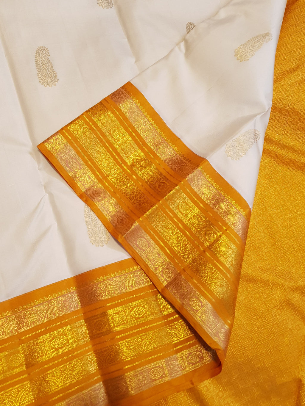 Cream and Orange Kanchipuram handloom 2G gold korvai silk saree featuring traditional gold zari weaving and classic paisley buttis.