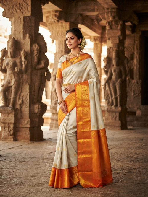 Beige Kanchipuram handloom 2G gold korvai silk saree with a striking orange and gold zari border.