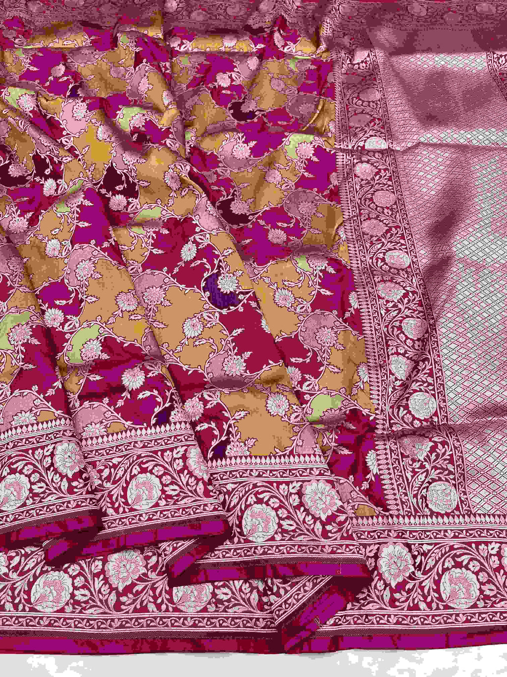 A vibrant hot pink Banarasi Katan silk saree featuring hand-woven Rangkaat diagonal color blocks and intricate Meenakari floral vines in shimmering gold zari.