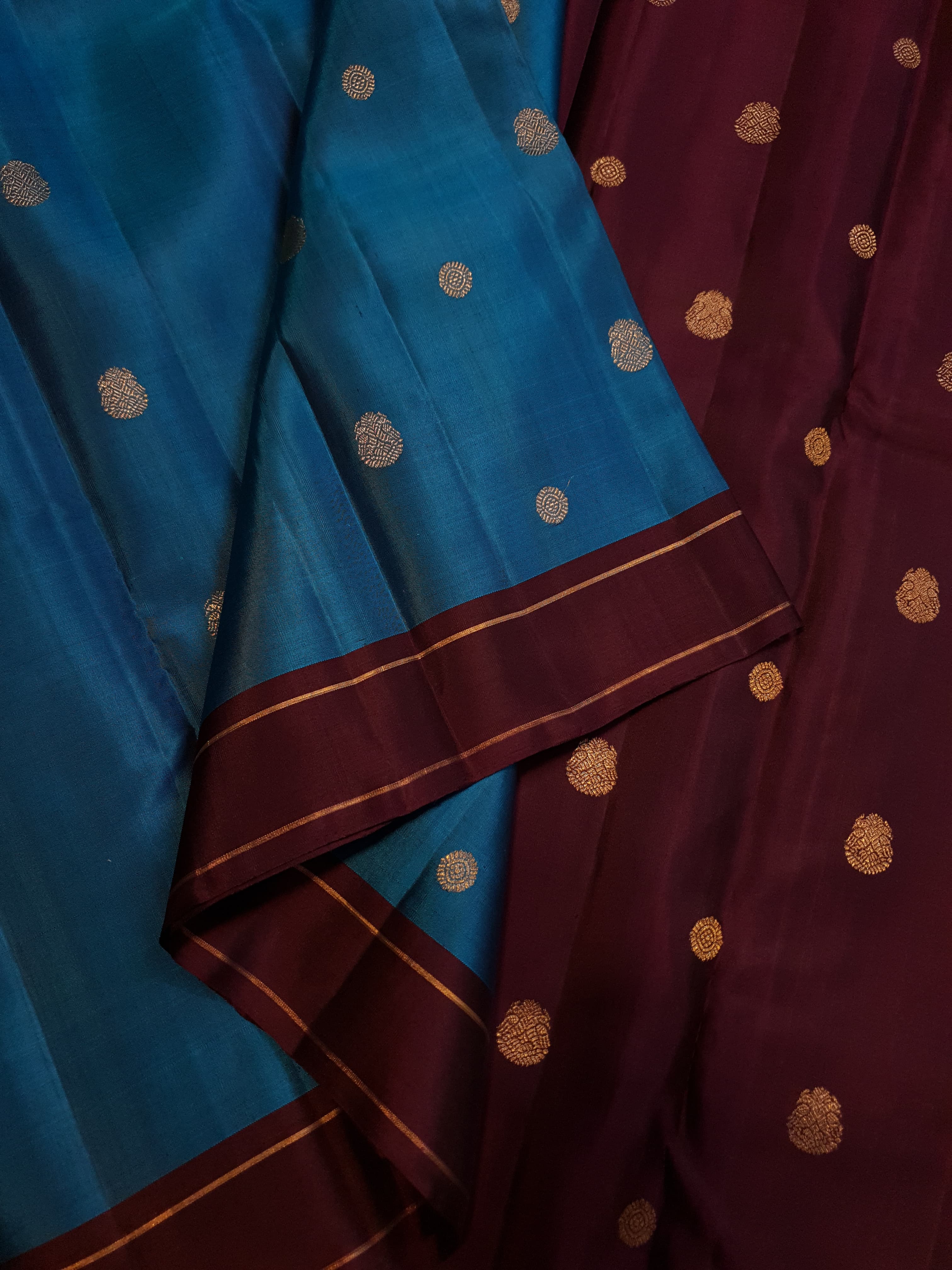 Peacock Blue Kanchipuram handloom silk saree, featuring a deep maroon border and intricate 3G pure gold zari work.