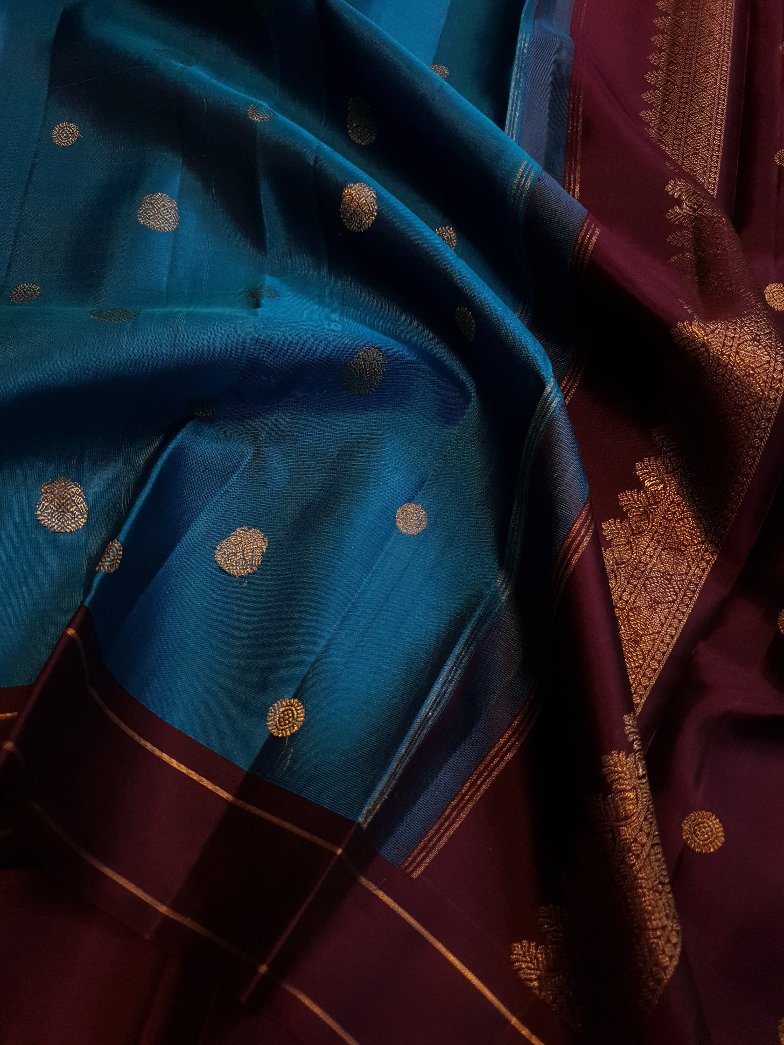 Peacock Blue Kanchipuram handloom silk saree, featuring a deep maroon border and intricate 3G pure gold zari work.