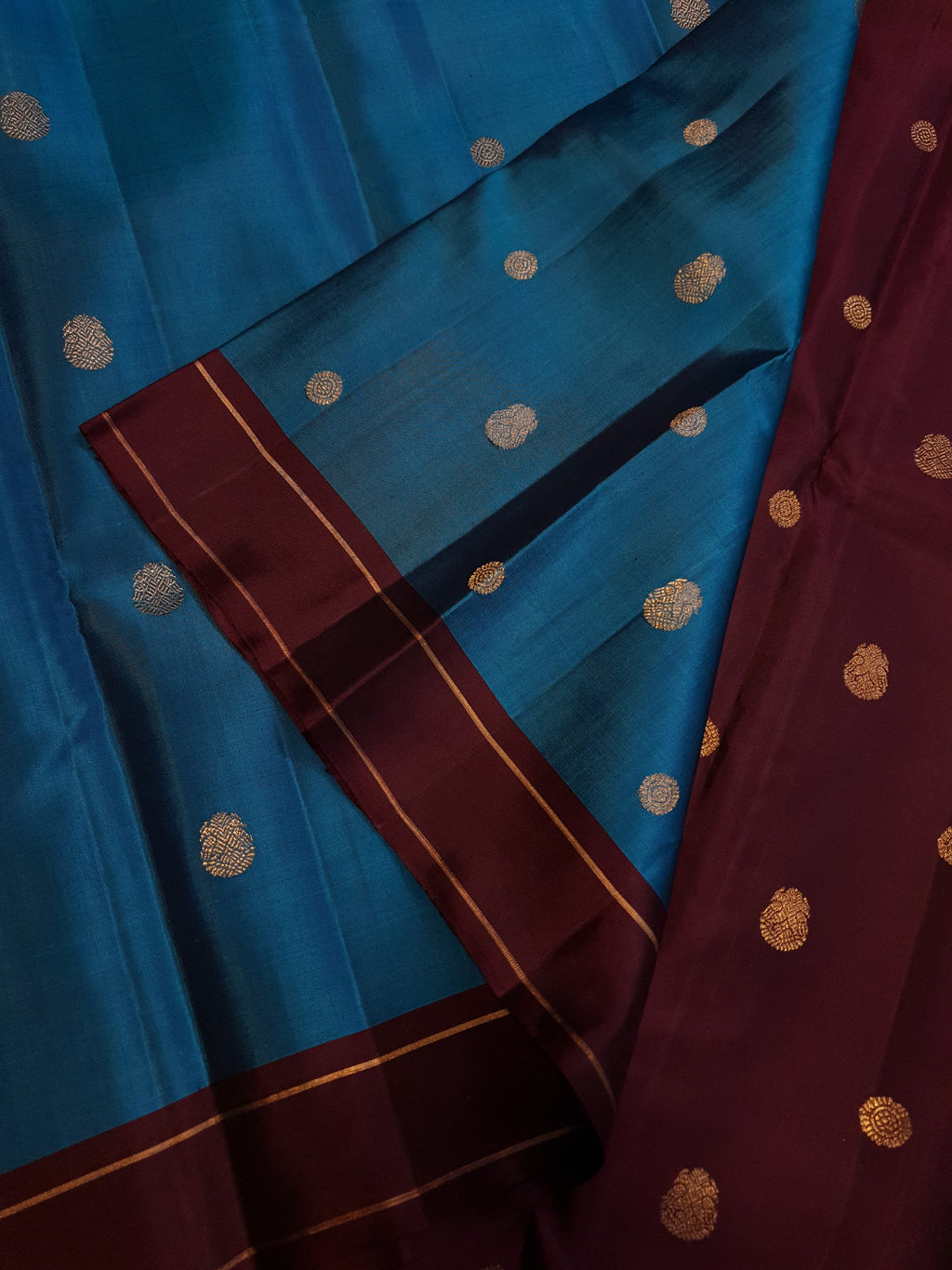 Peacock Blue Kanchipuram handloom silk saree, featuring a deep maroon border and intricate 3G pure gold zari work.