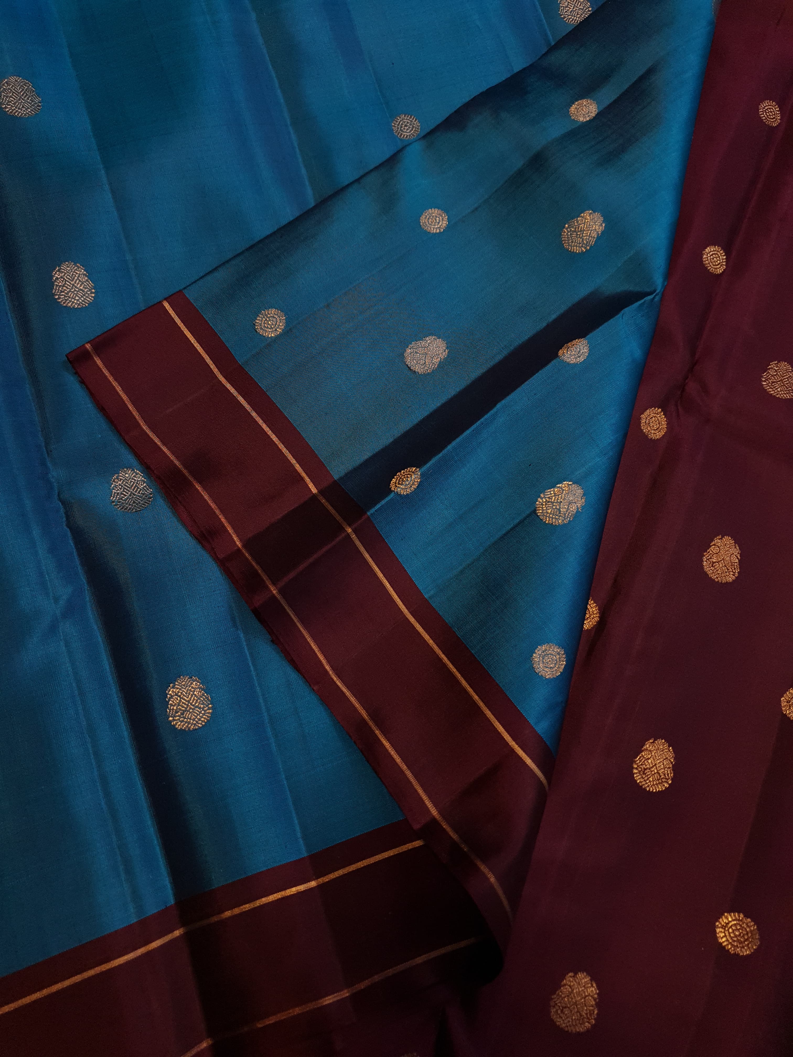 Peacock Blue Kanchipuram handloom silk saree, featuring a deep maroon border and intricate 3G pure gold zari work.