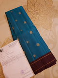 Peacock Blue Kanchipuram handloom silk saree, featuring a deep maroon border and intricate 3G pure gold zari work.