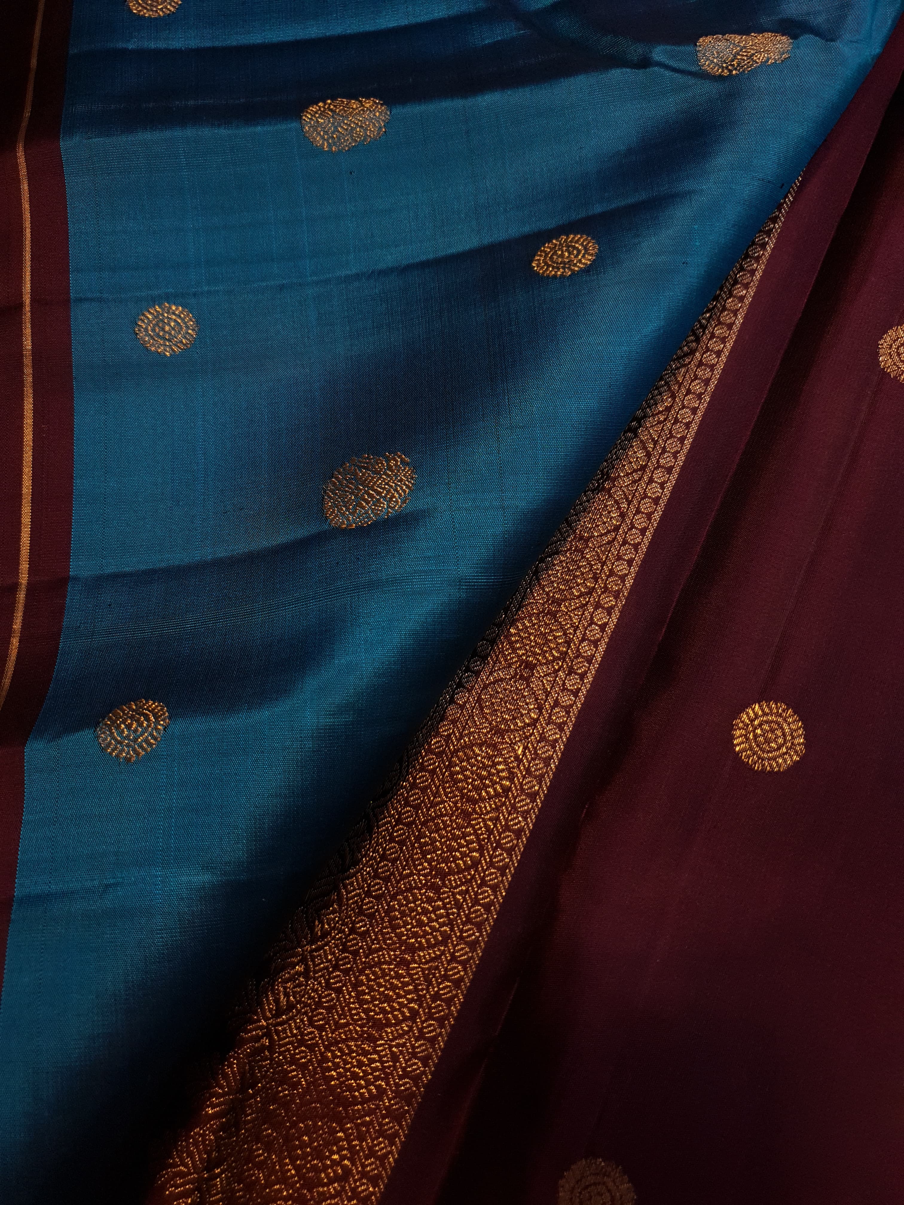 Peacock Blue Kanchipuram handloom silk saree, featuring a deep maroon border and intricate 3G pure gold zari work.