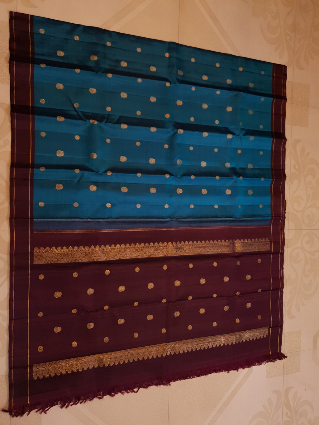 Peacock Blue Kanchipuram handloom silk saree, featuring a deep maroon border and intricate 3G pure gold zari work.