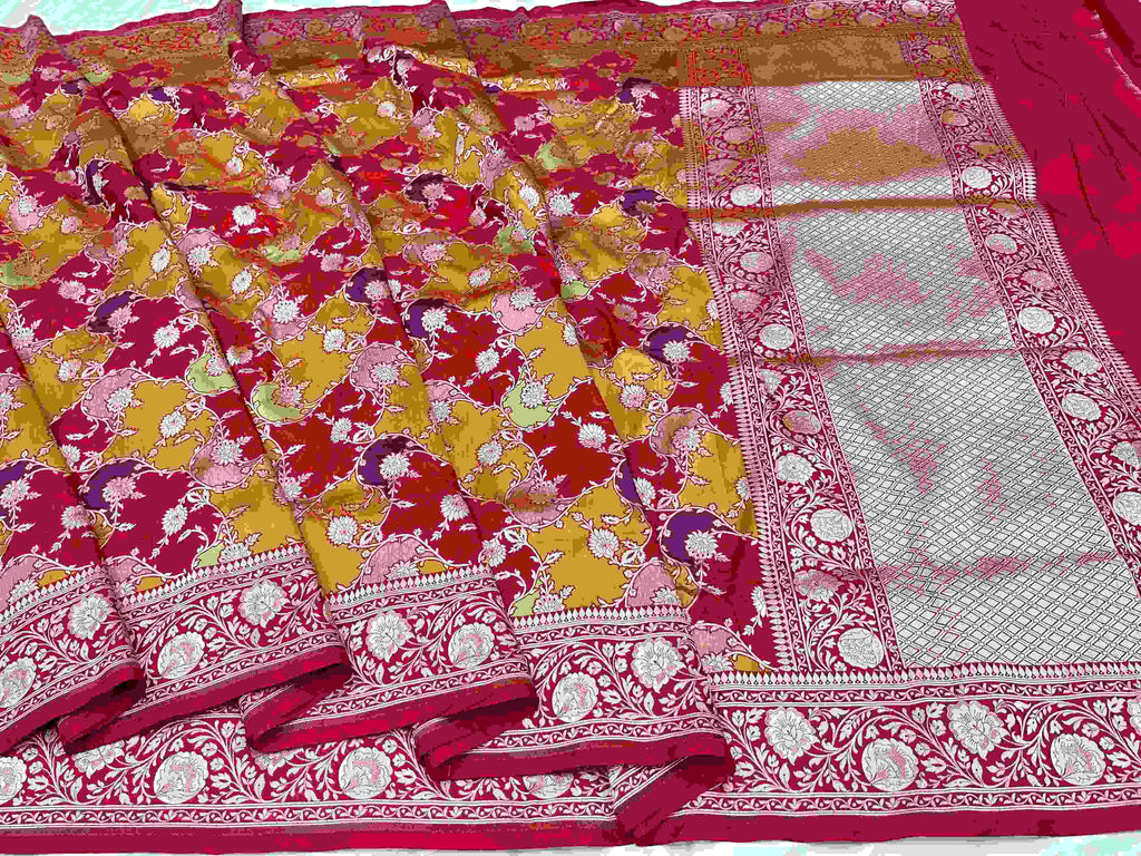 A majestic red Banarasi Katan silk saree with Rangkaat multi-color diagonal patterns and intricate hand-woven Meenakari floral jal.