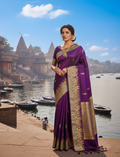 Royal purple Katan silk saree featuring gold zari Damru and Trishul motifs on the body and an intricate Kashi Ghat temple border.