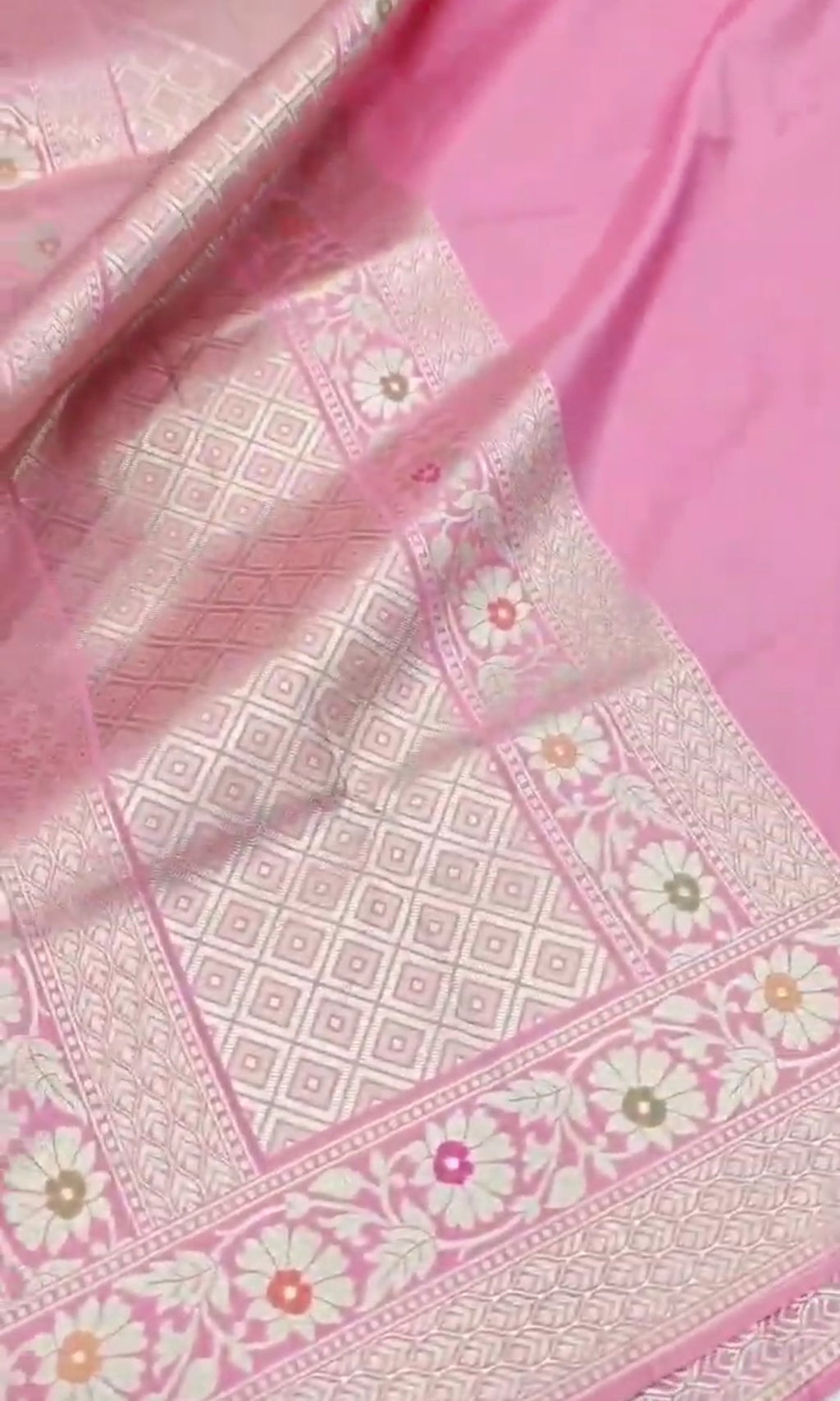 A soft pastel pink Banarasi saree with a plain silk body, a heavy Tilfi Meenakari floral border, and a matching full brocade blouse piece.