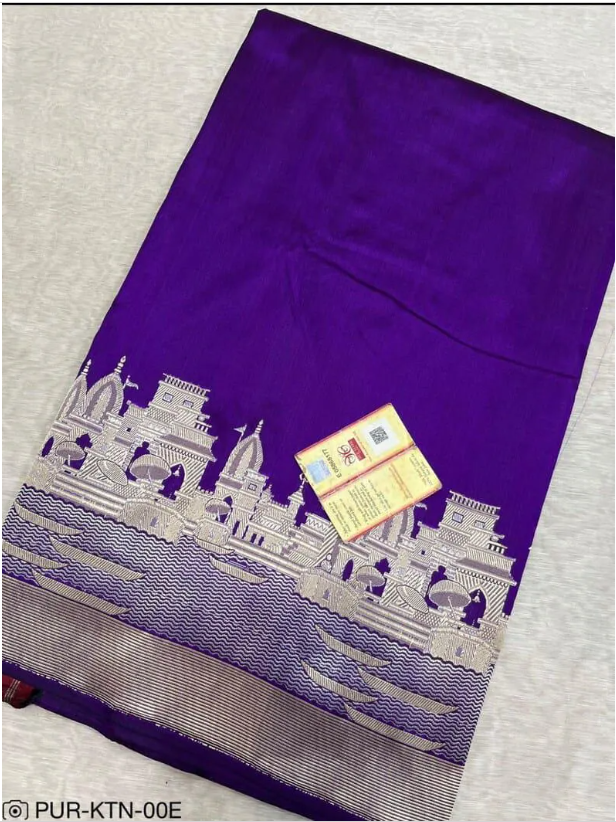 A royal purple Banarasi Katan silk saree with a silver and gold zari Kashi Ghat temple motif border and a Silk Mark Certification tag.