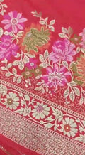 A bright bridal red Banarasi semi Katan silk saree with a minimalist plain body, intricate Tilfi Meenakari floral borders, and a heavy gold zari brocade blouse.