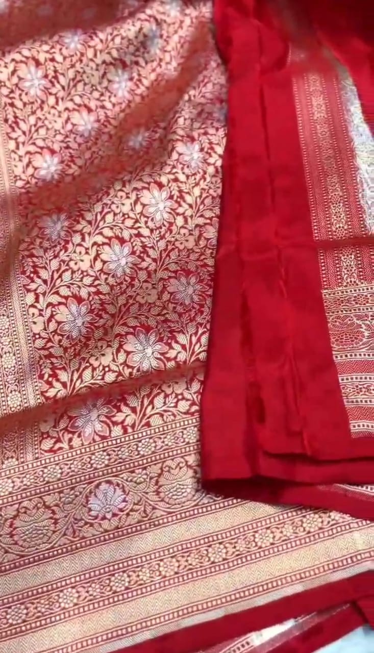 A bridal red Banarasi Katan silk saree featuring intricate hand-woven Sona Rupa zari motifs in gold and silver.
