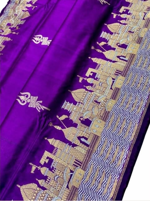 Royal purple Katan silk saree featuring gold zari Damru and Trishul motifs on the body and an intricate Kashi Ghat temple border.