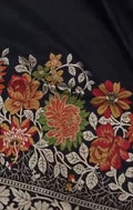 A majestic black Banarasi semi Katan silk saree with a plain body, vibrant three-colored Tilfi Meenakari floral borders, and an ornate gold zari blouse.