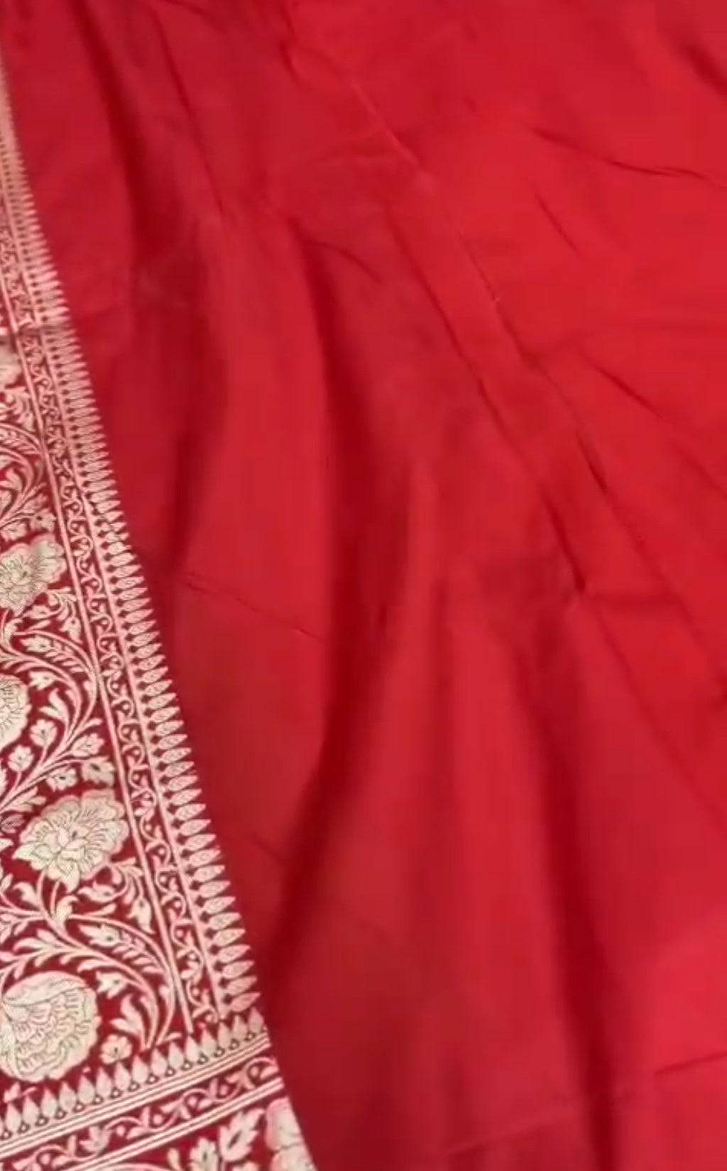 A majestic red Banarasi Katan silk saree with Rangkaat multi-color diagonal patterns and intricate hand-woven Meenakari floral jal.