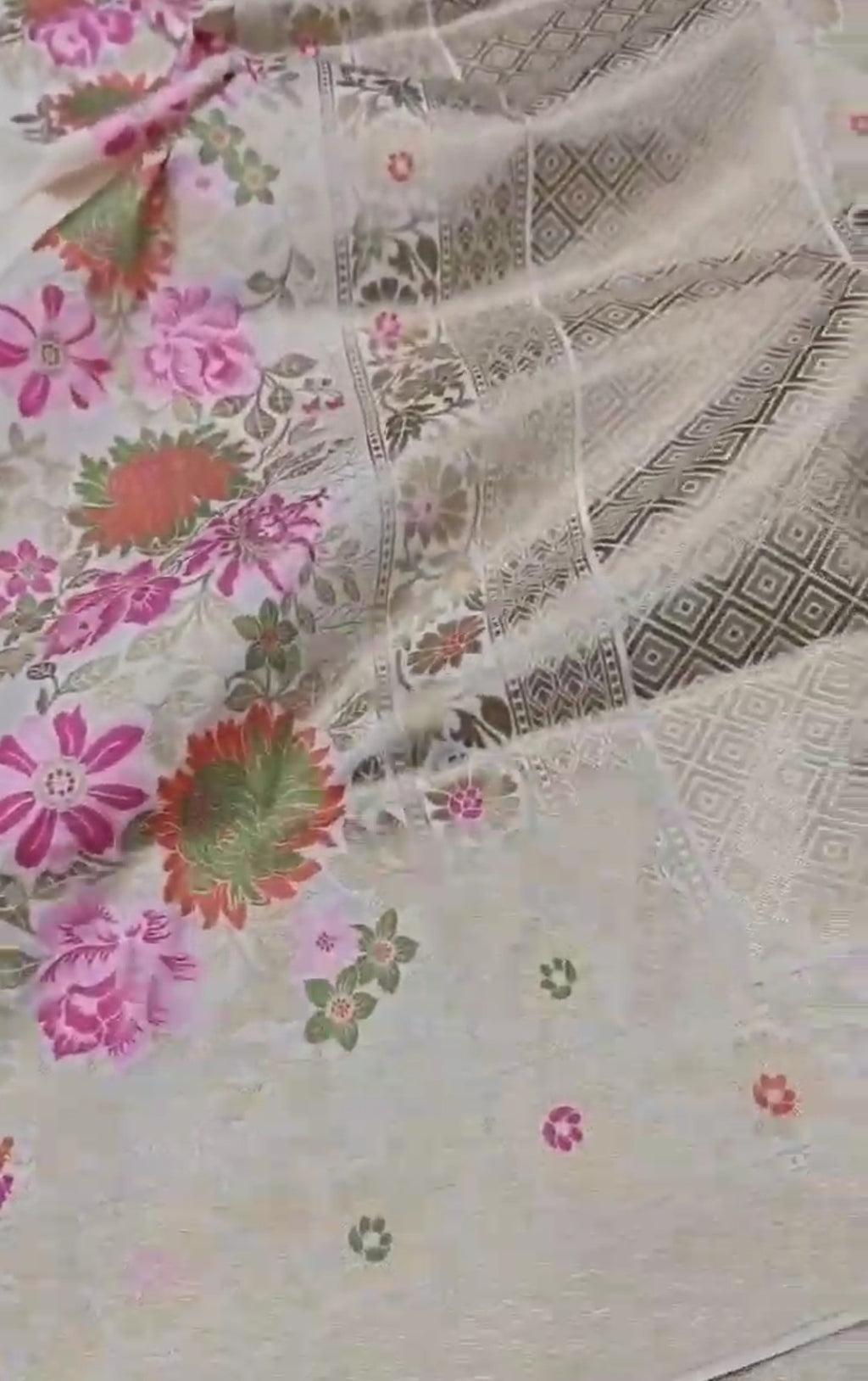 A majestic cream Banarasi semi Katan silk saree with a minimalist plain body, multi-colored Tilfi Meenakari floral borders, and a heavy gold zari blouse.
