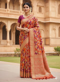 A vibrant chilly red Banarasi Katan silk saree featuring rare Rangkaat diagonal color blocking and multi-hued Meenakari floral weaving.