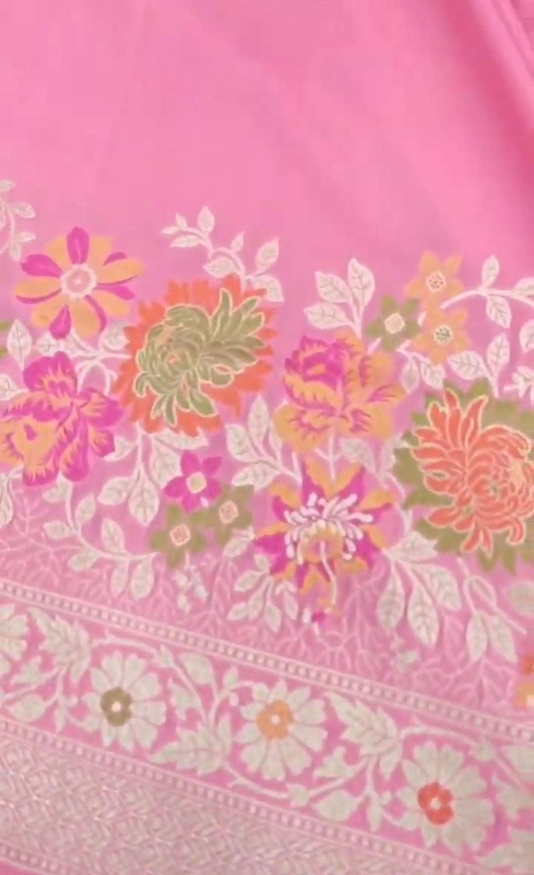 A soft pastel pink Banarasi saree with a plain silk body, a heavy Tilfi Meenakari floral border, and a matching full brocade blouse piece.