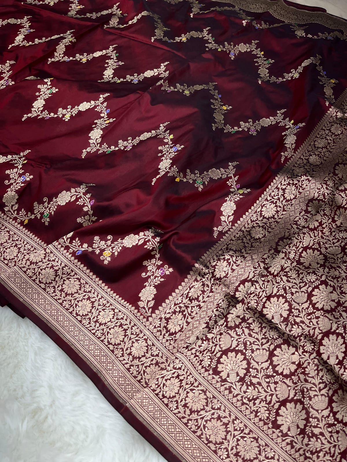 Maroon Banarasi Handloom Pure Katan Silk Kaduwa Jangla Meenakari Saree featuring intricate multi-color floral weaving and gold zari work.