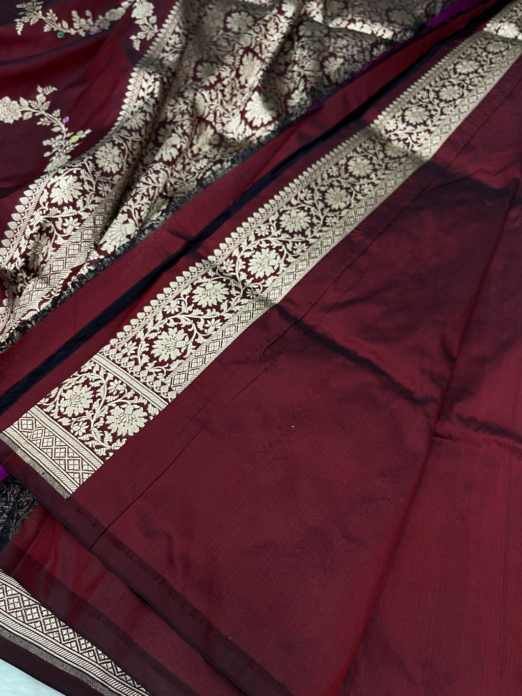 Maroon Banarasi Handloom Pure Katan Silk Kaduwa Jangla Meenakari Saree featuring intricate multi-color floral weaving and gold zari work.