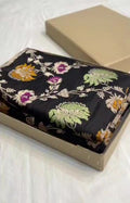 Midnight Black Handloom Banarasi Katan Silk Saree with Vibrant Meenakari Floral Motifs and Silk Mark Label.