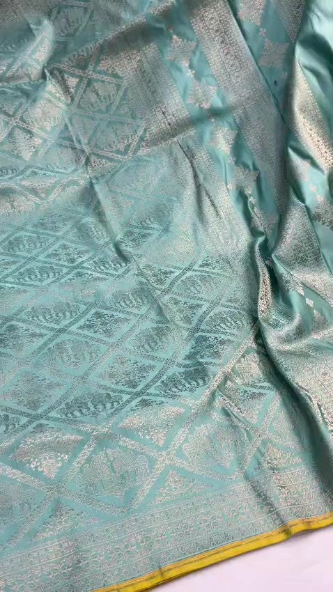 Shop our premium Dual Tone Turquoise Banarasi Handloom Katan Silk Saree. Silk Mark Certified for authenticity, this Shikargah masterpiece features rich silver zari weaving, perfect for weddings and heritage collections.