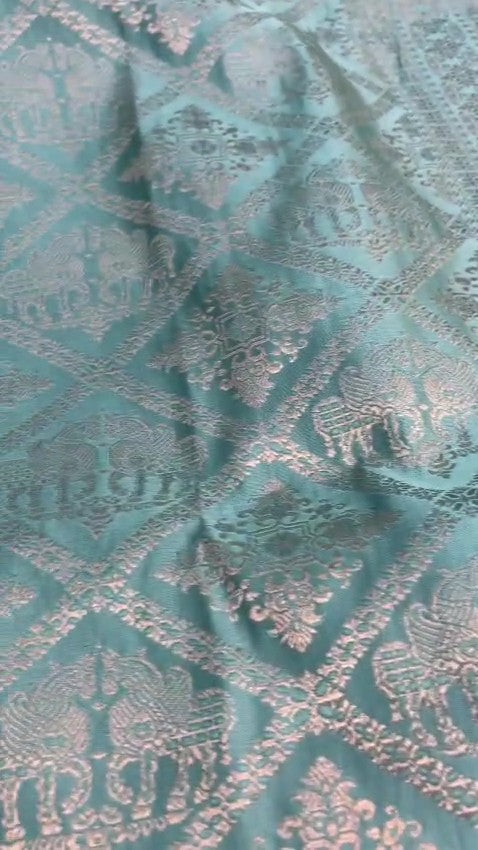 Shop our premium Dual Tone Turquoise Banarasi Handloom Katan Silk Saree. Silk Mark Certified for authenticity, this Shikargah masterpiece features rich silver zari weaving, perfect for weddings and heritage collections.