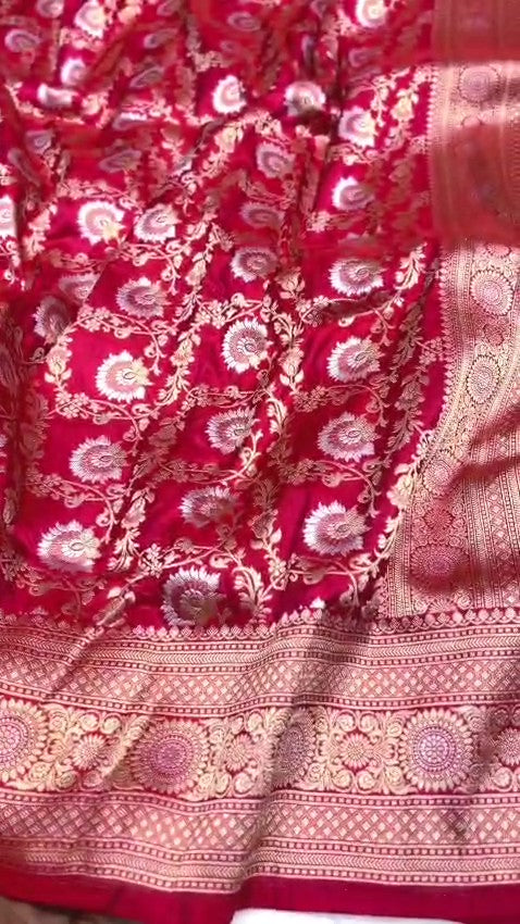 Red Banarasi Handloom Katan Silk Sona Rupa Saree showcasing the elaborate gold and silver Jangla patterned pallu and matching patterned border.