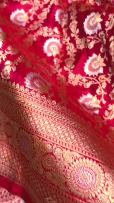 Red Banarasi Handloom Katan Silk Sona Rupa Saree showcasing the elaborate gold and silver Jangla patterned pallu and matching patterned border.
