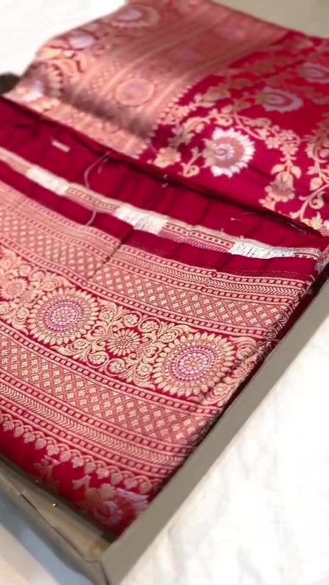 Red Banarasi Handloom Katan Silk Sona Rupa Saree showcasing the elaborate gold and silver Jangla patterned pallu and matching patterned border.