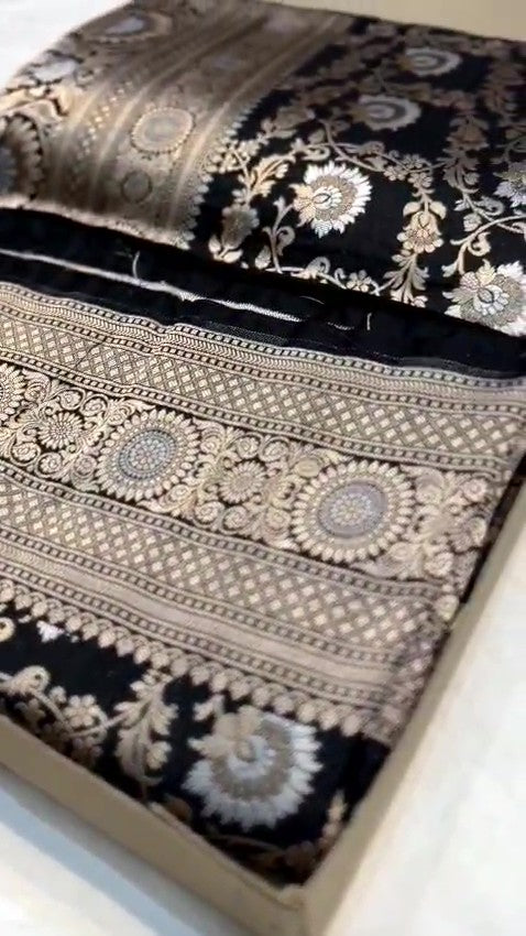 Detailed close-up view of the dense Sona Rupa Jangla floral and vine pattern woven across the black katan silk saree.